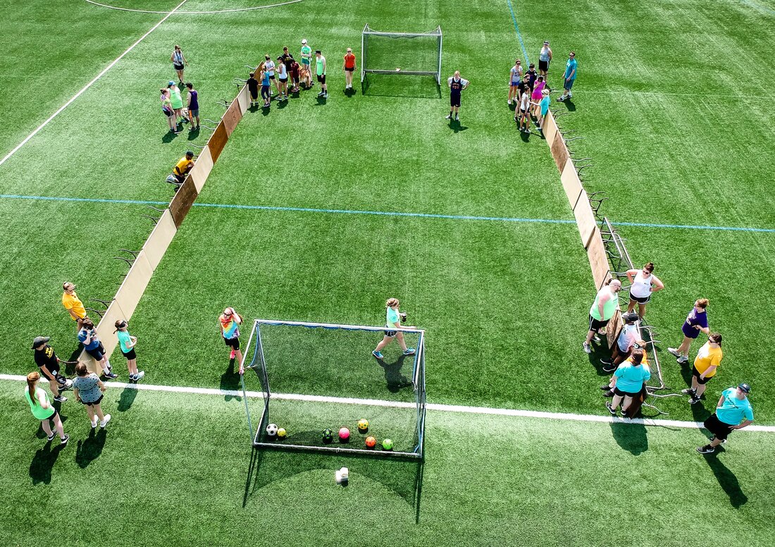Aerial photo of athletes playing futsal on a soccer field. 